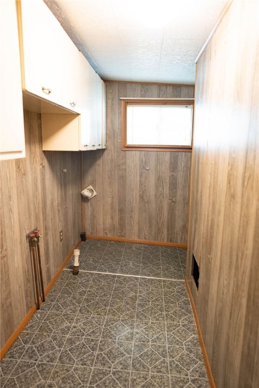 washroom with wooden walls