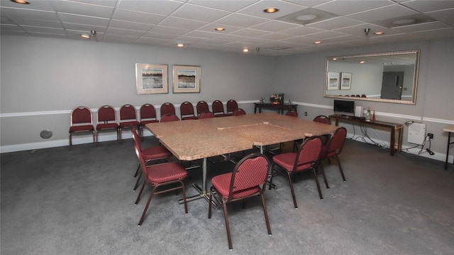 dining room with carpet, a paneled ceiling, and baseboards