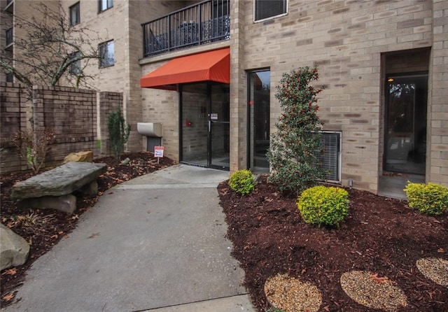 doorway to property featuring brick siding