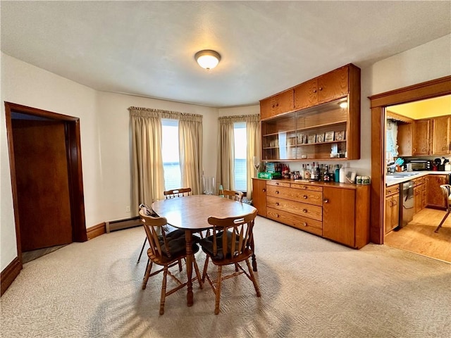 carpeted dining room with a baseboard radiator