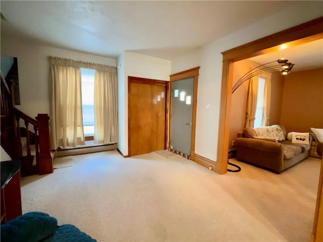 carpeted living room with a water view and a baseboard radiator