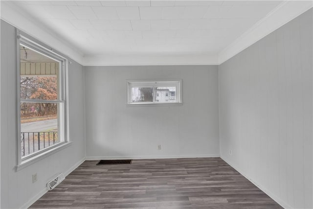 unfurnished room featuring dark hardwood / wood-style floors and ornamental molding