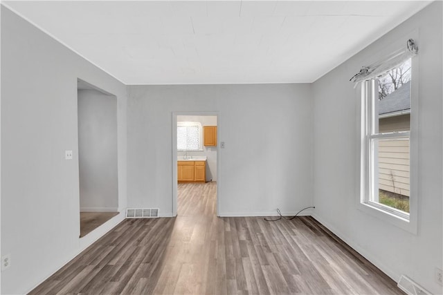 empty room with hardwood / wood-style flooring