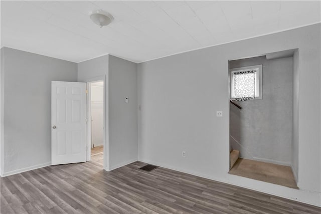 empty room with hardwood / wood-style floors