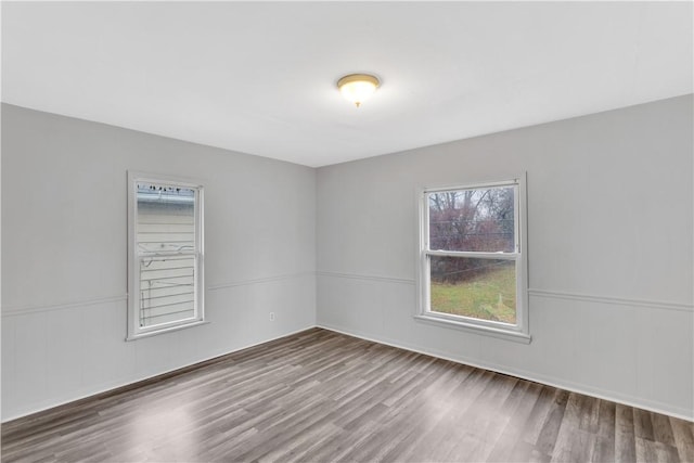 empty room with hardwood / wood-style flooring