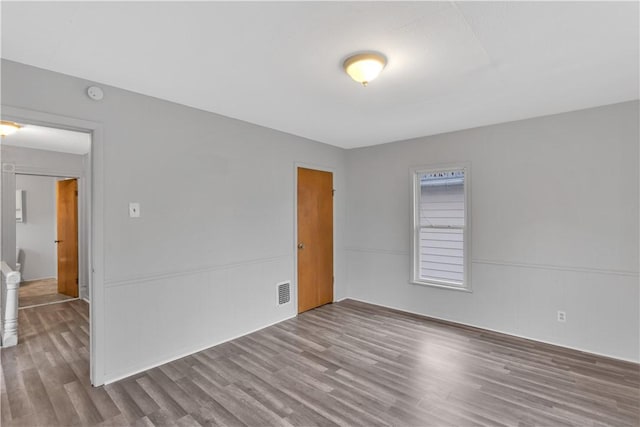 spare room featuring wood-type flooring