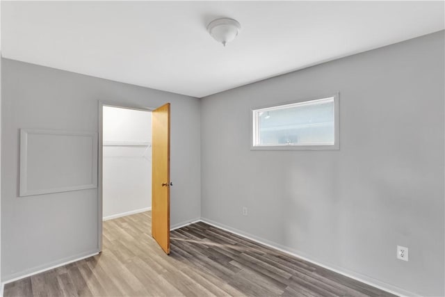 unfurnished bedroom featuring light wood-type flooring and a closet