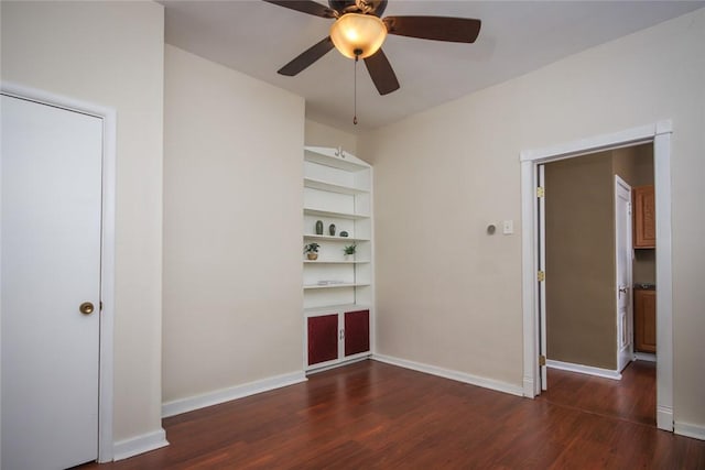 unfurnished bedroom featuring ceiling fan and dark hardwood / wood-style flooring