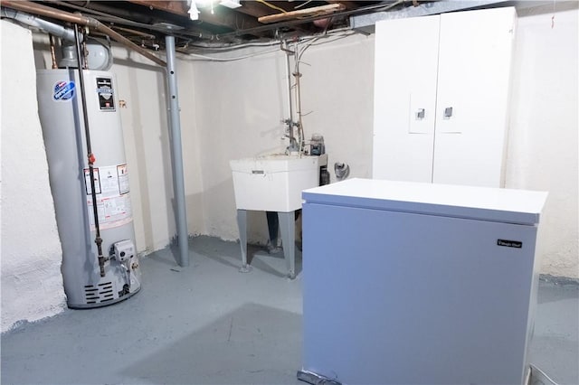 basement featuring water heater and refrigerator