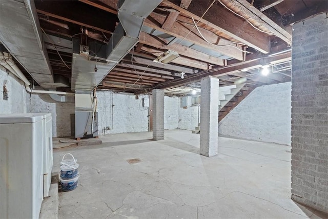 basement featuring washer / dryer and heating unit