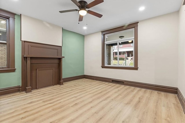 empty room featuring ceiling fan and light hardwood / wood-style floors