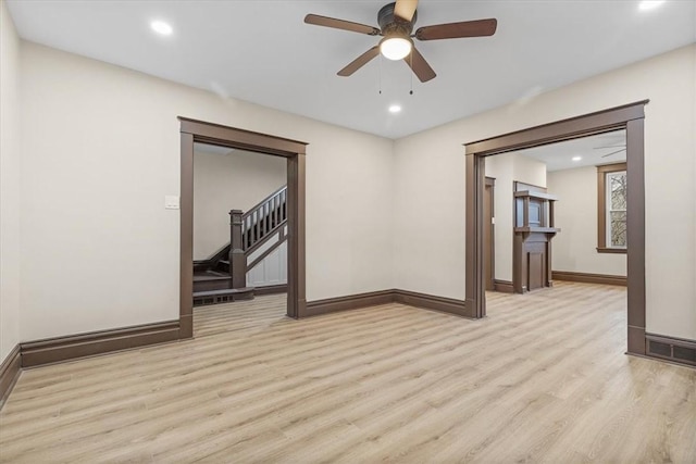 spare room featuring light hardwood / wood-style floors and ceiling fan