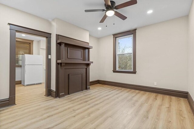 unfurnished living room with light hardwood / wood-style floors and ceiling fan