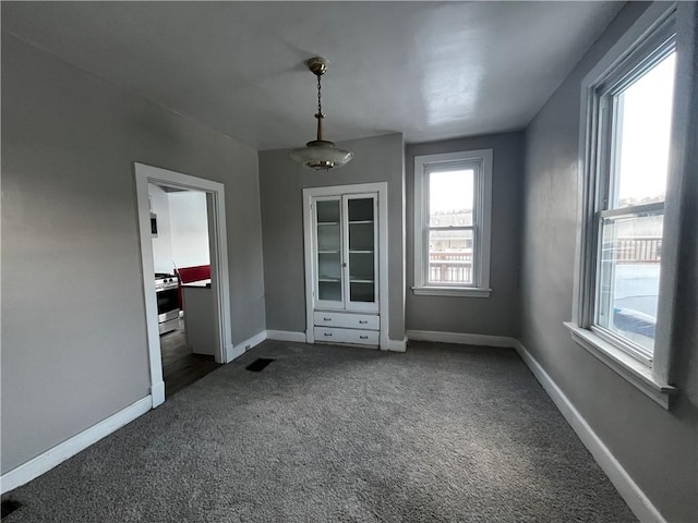 unfurnished bedroom with dark colored carpet