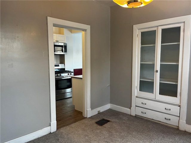 interior space featuring dark colored carpet