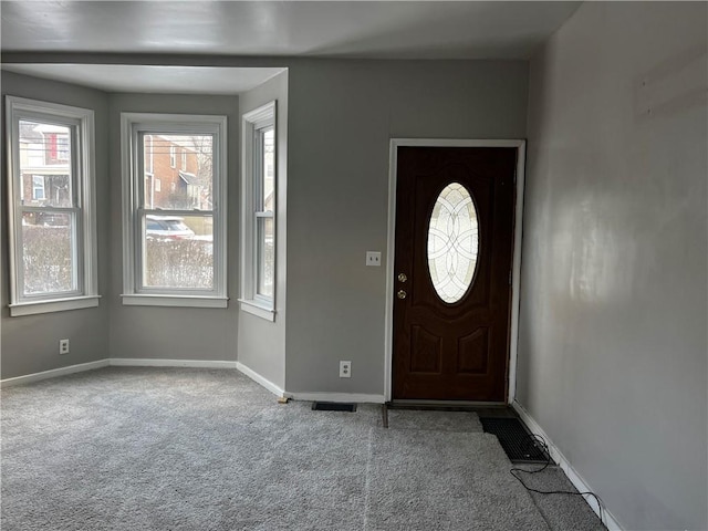 foyer entrance with light carpet