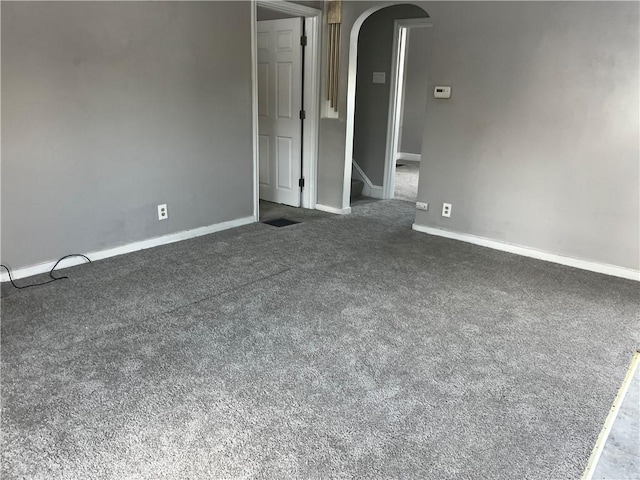 unfurnished room featuring dark colored carpet