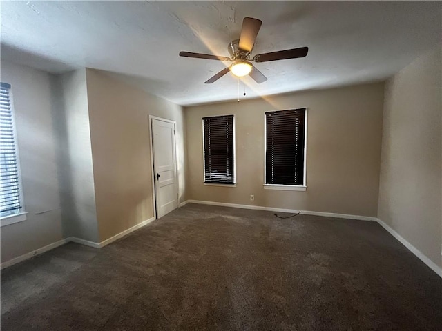 carpeted spare room featuring ceiling fan