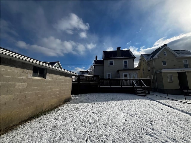 snowy yard with a deck