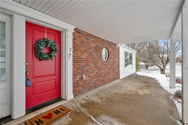 view of snow covered property entrance