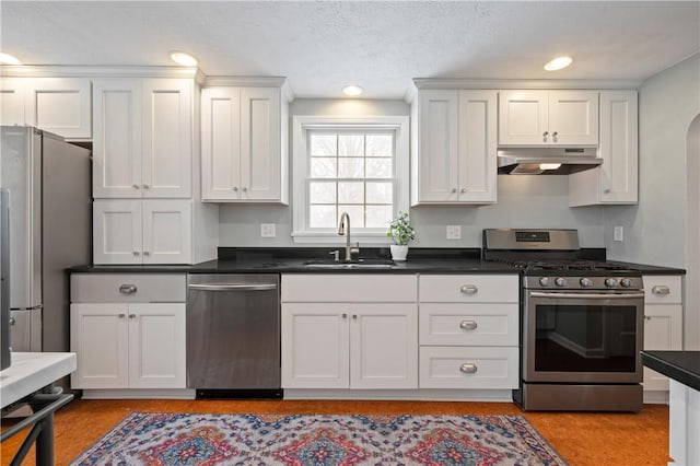 kitchen with sink, white cabinets, a textured ceiling, and appliances with stainless steel finishes