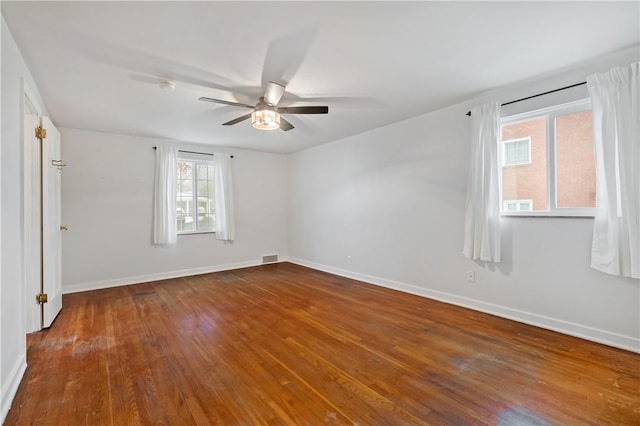 unfurnished room with hardwood / wood-style flooring and ceiling fan