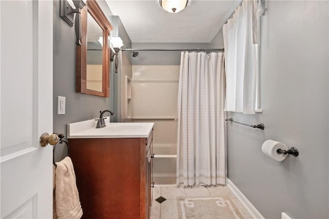 bathroom with tile patterned flooring, vanity, a textured ceiling, and shower / tub combo with curtain