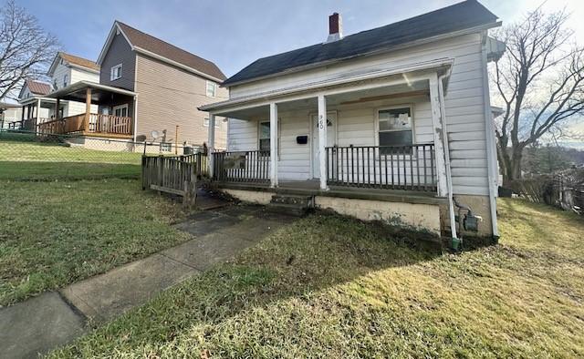 view of front of house with a porch and a front lawn