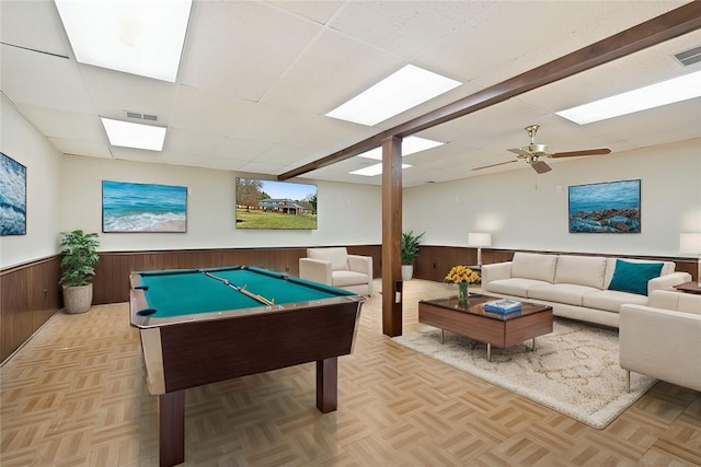 recreation room with a paneled ceiling, wood walls, light parquet flooring, and billiards