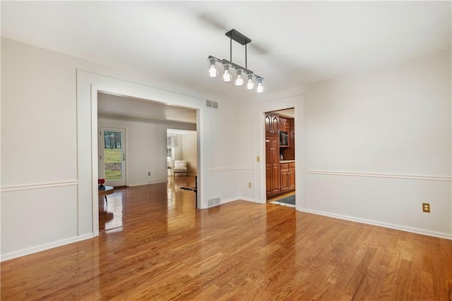 unfurnished dining area with wood-type flooring