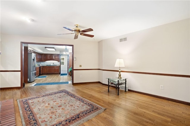 corridor with light hardwood / wood-style floors