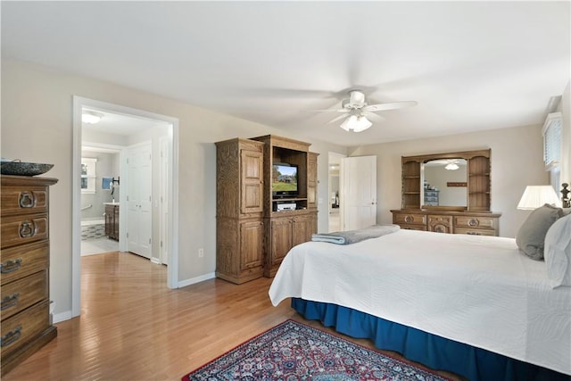 bedroom featuring ensuite bath, ceiling fan, and light hardwood / wood-style flooring