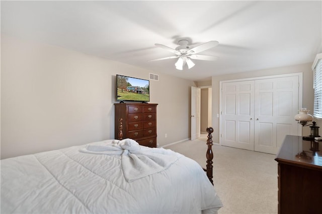 carpeted bedroom featuring ceiling fan and a closet