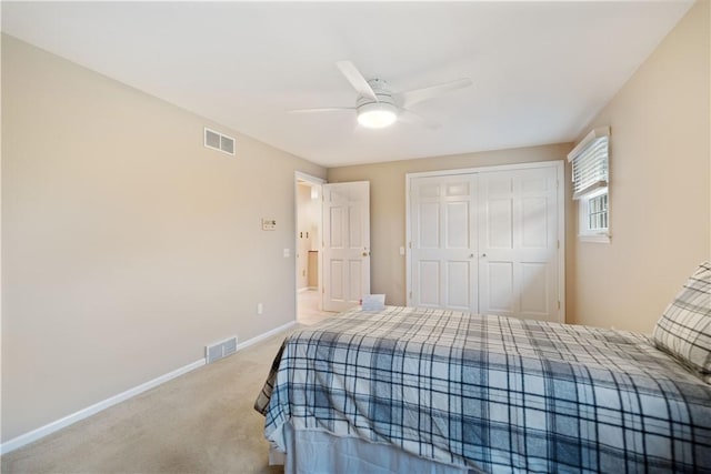 carpeted bedroom featuring ceiling fan and a closet