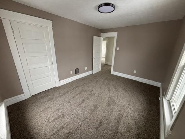 unfurnished bedroom with carpet floors