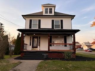 view of front of home featuring a lawn and a porch