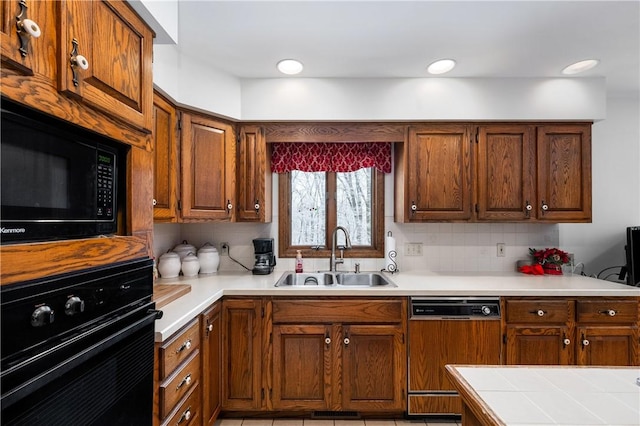 kitchen with decorative backsplash, sink, light tile patterned floors, and black appliances