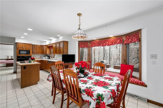 dining room with light tile patterned floors and a chandelier