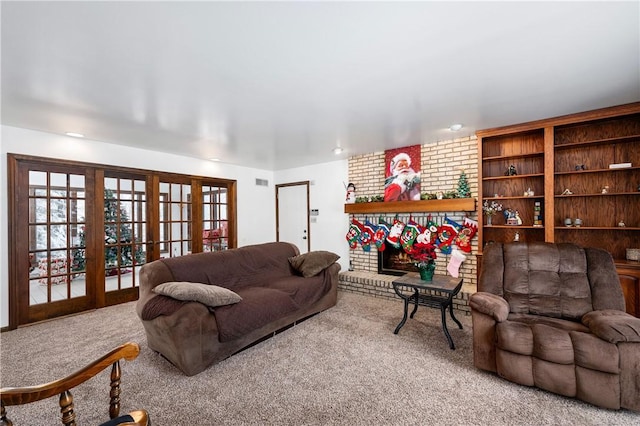 living room with carpet floors, a fireplace, and french doors