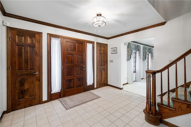 foyer entrance featuring crown molding