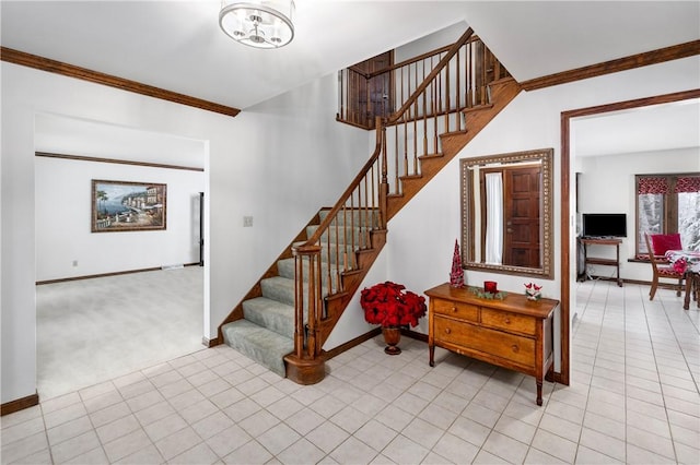 stairway featuring carpet, a chandelier, and crown molding