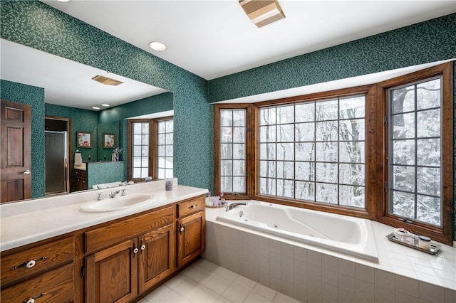 bathroom with tile patterned flooring, vanity, and independent shower and bath