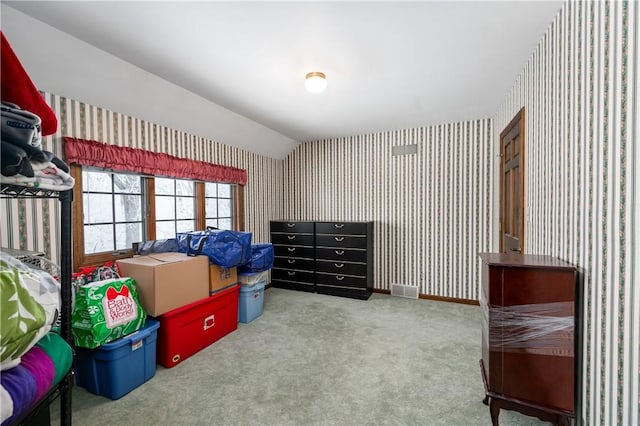 bedroom with carpet floors and vaulted ceiling