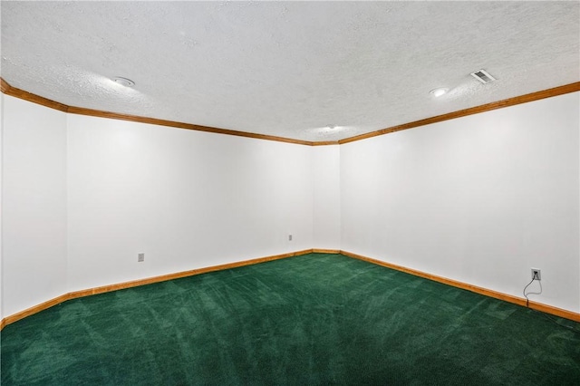 carpeted empty room featuring ornamental molding and a textured ceiling