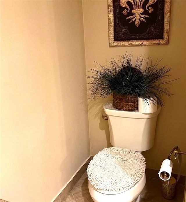 bathroom featuring tile patterned flooring and toilet