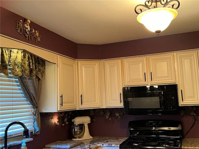 kitchen with stone counters, white cabinets, and black appliances