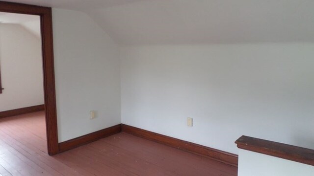 bonus room with hardwood / wood-style floors and lofted ceiling