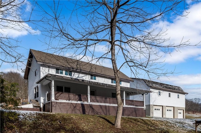 view of side of property featuring a porch and a garage