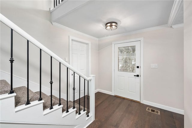 foyer entrance featuring dark hardwood / wood-style flooring and crown molding