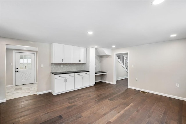 kitchen featuring white cabinets, dark hardwood / wood-style floors, and tasteful backsplash